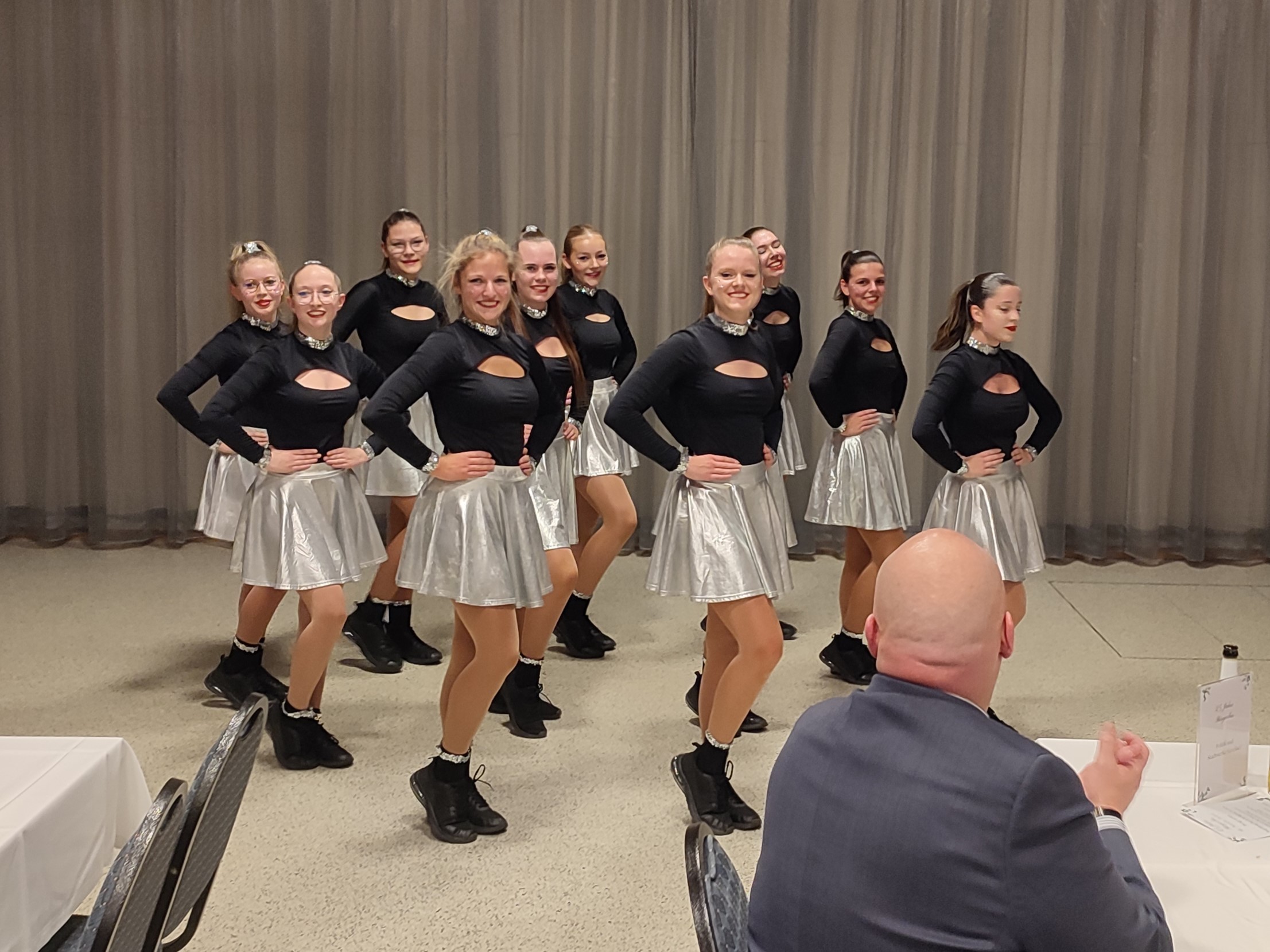 Young women dancing in the same outfit.