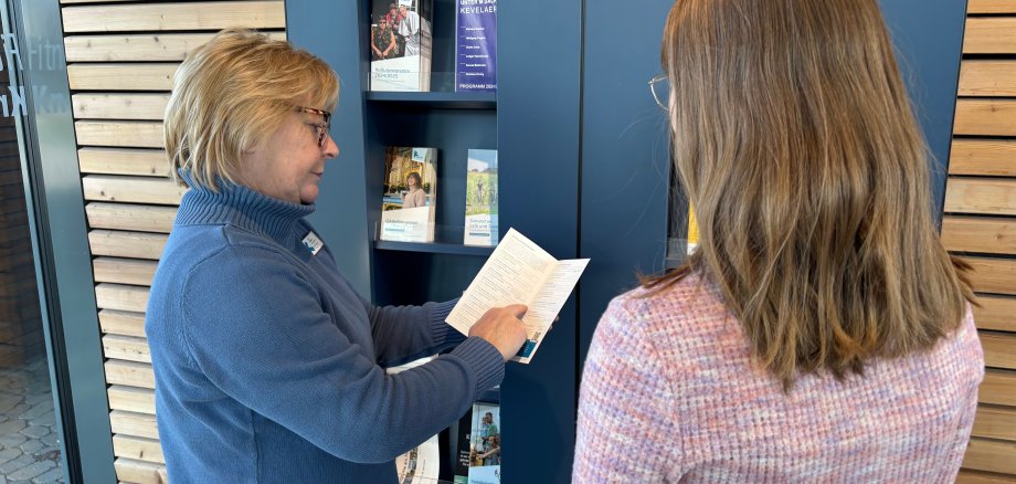 Tourist Information staff in front of the information stand