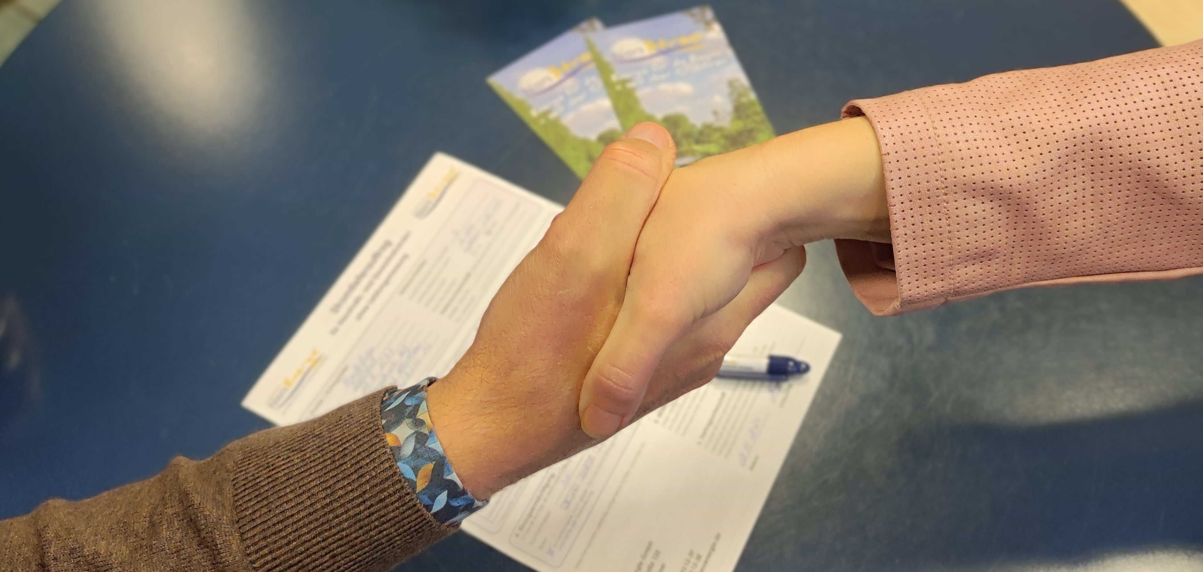 Handen worden geschud over een formulier.